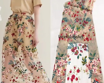 May include: Beige floral embroidered tulle fabric with a delicate floral pattern in shades of red, pink, green, and blue. The fabric has a sheer, lightweight texture and is perfect for creating garments, accessories, or home decor projects.  lacefabricArt