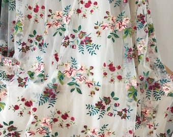 May include: White sheer fabric with embroidered floral pattern in shades of pink, red, and green.