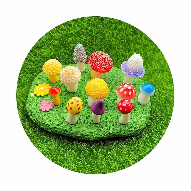 May include: A collection of miniature mushroom figurines in various colors, including red, yellow, purple, blue, and white, arranged on a bed of green artificial grass.