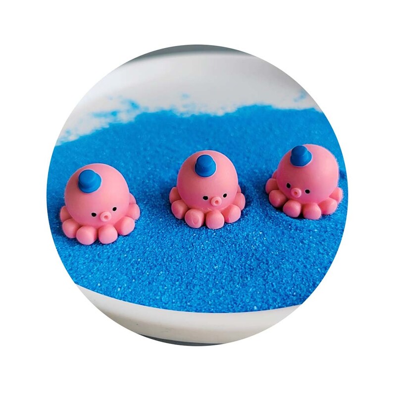 May include: Three pink octopus figurines with blue hats on a blue background. The octopus figurines are small and have a cute, cartoonish appearance.