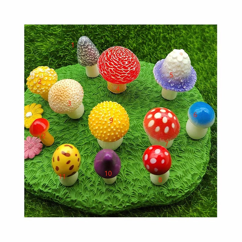 May include: A set of 10 miniature mushroom figurines in various colors and designs, including red with white dots, yellow with dots, purple, blue, and white with purple accents. The mushrooms are arranged on a green grassy surface.