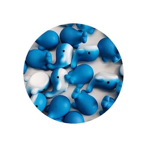 May include: A collection of blue and white whale figurines. The whales are made of a soft, squishy material and are perfect for a child's playroom or a desk decoration.