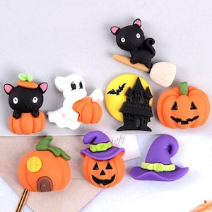 May include: A set of Halloween-themed charms featuring pumpkins, a ghost, a black cat, a witch's hat, and a haunted house. The charms are made of colorful plastic and are perfect for adding a spooky touch to crafts and decorations.