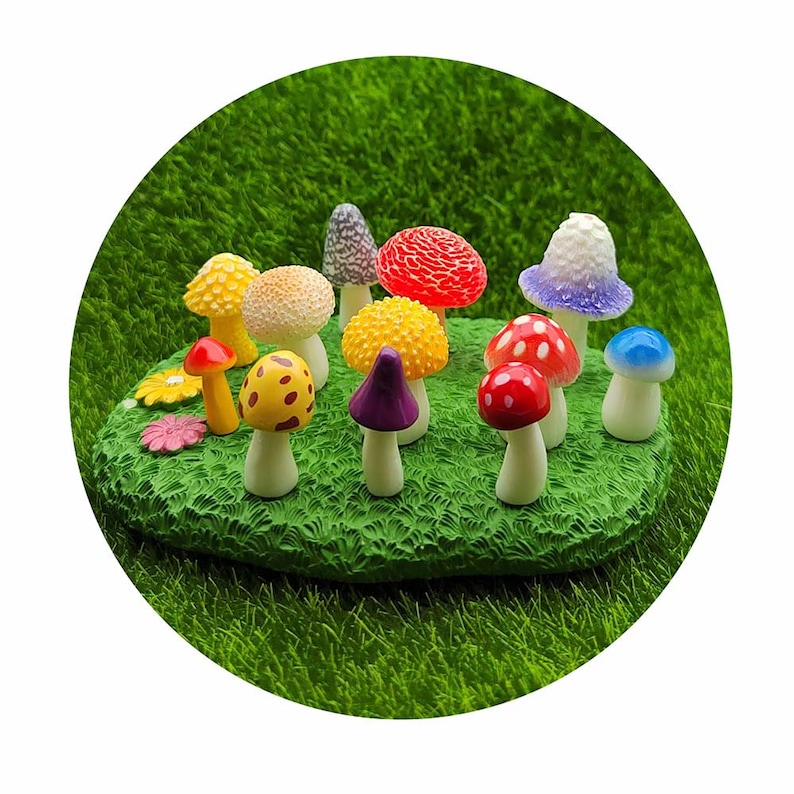 May include: A collection of miniature mushroom figurines in various colors, including red, yellow, purple, blue, and white, arranged on a green grassy surface.