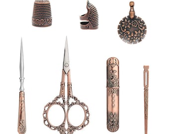 May include: A set of vintage-style sewing tools in copper and silver tones. The set includes a thimble, a needle threader, a pair of scissors, a needle case, and a seam ripper.