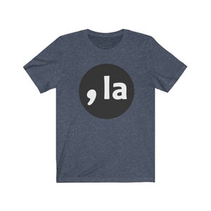 May include: A dark blue t-shirt with a black circle and white text that says ",la" in a bold font.