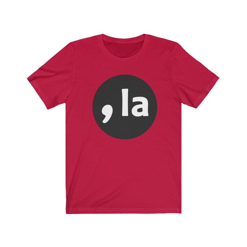 May include: Red short-sleeved t-shirt with a black circle and white text that says ",la"