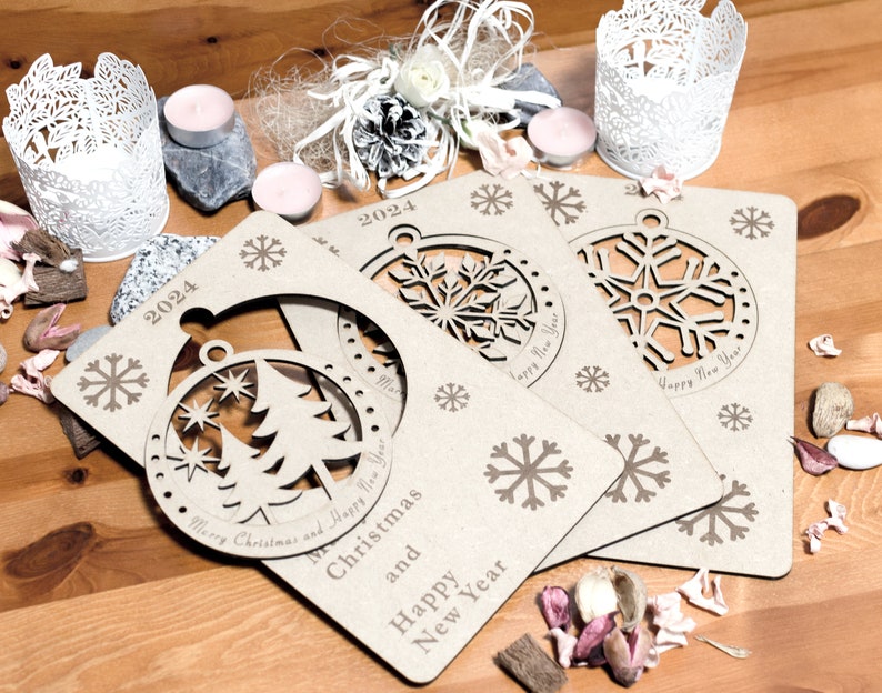 May include: Three brown cardboard Christmas ornaments with cut-out snowflake designs. The ornaments are decorated with the text "Merry Christmas and Happy New Year" and "2024".