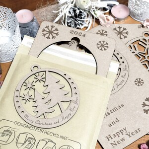May include: A set of three brown cardboard Christmas ornaments with a snowflake design. The ornaments are decorated with the text "Merry Christmas and Happy New Year" and "2024".
