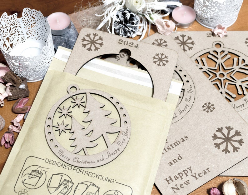 May include: A set of three brown cardboard Christmas ornaments with a snowflake design. The ornaments are decorated with the text "Merry Christmas and Happy New Year" and "2024".