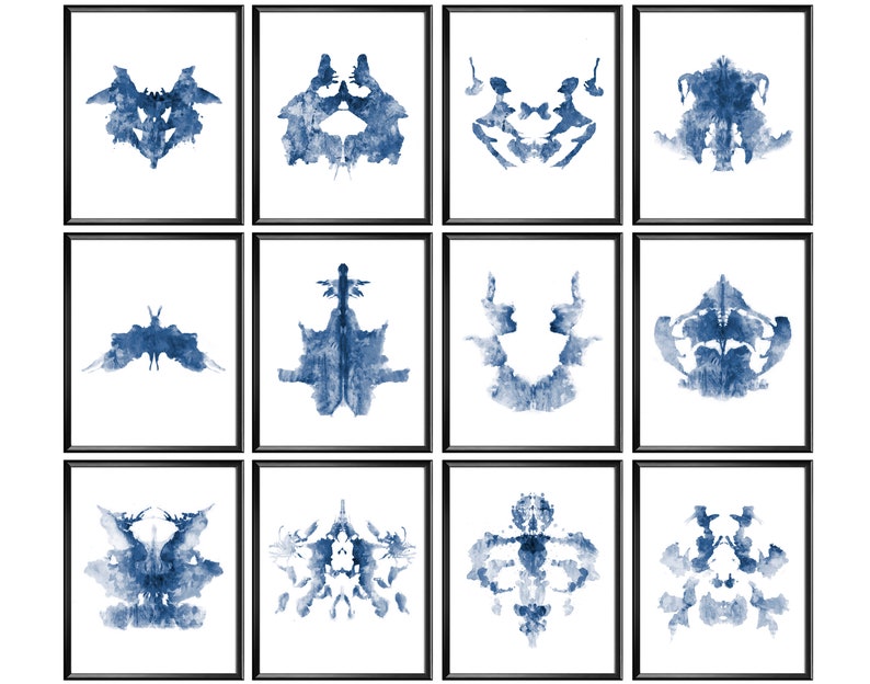 May include: Twelve framed prints of blue inkblot designs, each in a black frame. The prints are arranged in a grid of four rows and three columns.