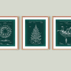 May include: Three framed prints with a green background and white illustrations of a Christmas wreath, a Christmas tree, and a sleigh. The text "United States Patent Office" appears at the top of each print.