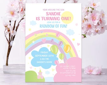 May include: A rainbow-themed birthday party invitation for a girl turning one year old. The invitation features a rainbow with clouds, stars, and hearts. The text reads "Year Around the Sun Sandie is Turning One! Join us for a Rainbow of Fun!"  The invitation also includes the date, time, and location of the party.
