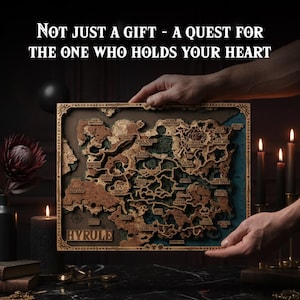 Op de afbeelding: Een gedetailleerde houten kaart van Hyrule, met lasergesneden terrein en plaatsnamen. De kaart wordt door handen vastgehouden, met de tekst "NOT JUST A GIFT - A QUEST FOR THE ONE WHO HOLDS YOUR HEART" bovenaan en "HYRULE" onderaan. Kaarsen en een donkere achtergrond.