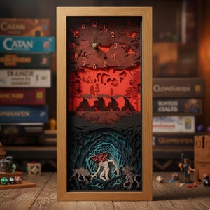 May include: A rectangular wooden framed clock with a layered design depicting a scene with figures on bikes, a monster, and a forest. The clock face has numbers and hands. The background is red and the clock is on a wooden surface.
