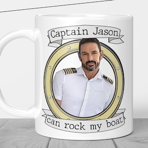 May include: White ceramic mug with a yellow and brown illustration of a porthole with a man inside. The text "Captain Jason can rock my boat" is printed on the mug.