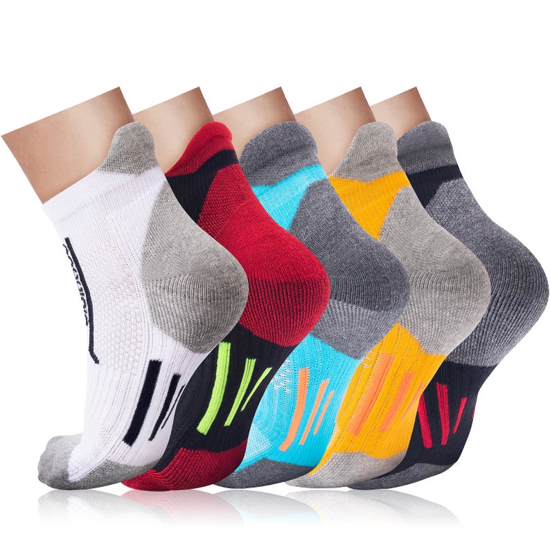 May include: Six pairs of athletic socks in various colors, including white, red, blue, and yellow. Each sock has a gray heel and toe, with black and neon green accents. The socks are designed for comfort and performance.