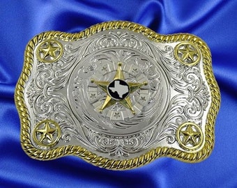 Puede incluir: Hebilla de cinturón de plata y oro con un diseño detallado. El centro presenta una estrella con un contorno blanco del estado de Texas.