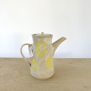 White coffee pot with yellow curls, teapot, milk jug, water jug for hot or cold drinks