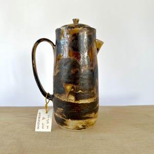 Brown coffee pot with bright effects, teapot, milk jug, water jug for hot or cold drinks