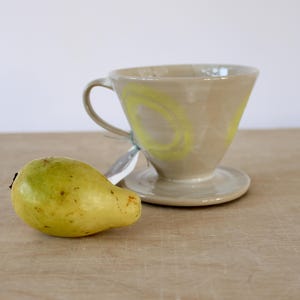 White V60 coffee filter attachment with yellow curls, coffee filter, coffee filter holder, pour over coffee dripper, slow coffee, barista accessories