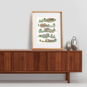 May include: A framed print of a mid-century modern illustration featuring colorful houses and cars. The houses are in various styles and colors, and the cars are all classic models. The print is set against a white background.