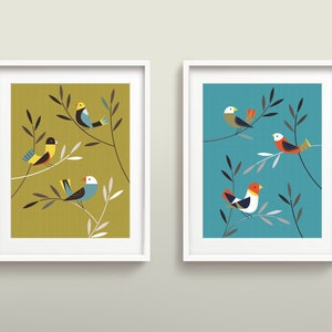 May include: Two framed prints with a minimalist design featuring stylised birds perched on branches. The print on the left has a yellow-green background and the print on the right has a teal background.