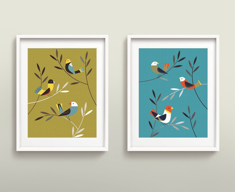 May include: Two framed prints with a minimalist design featuring stylised birds perched on branches. The print on the left has a yellow-green background and the print on the right has a teal background.