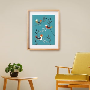 May include: Framed print featuring three stylised birds perched on branches against a teal background. The birds are red, white and yellow.