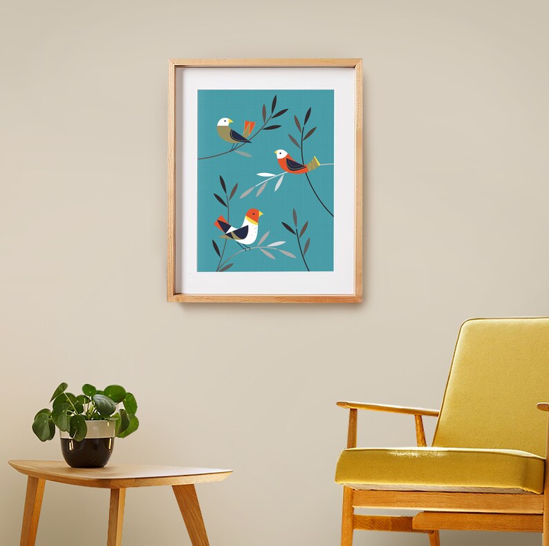 May include: Framed print featuring three stylised birds perched on branches against a teal background. The birds are red, white and yellow.