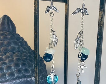 Long and thin earrings, various ornaments, blue and green tones.