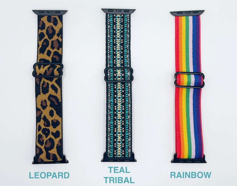 May include: Three different Apple Watch bands. The first band is leopard print, the second is teal with a tribal pattern, and the third is rainbow.