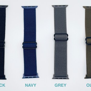 May include: Four Apple Watch bands in black, navy, grey, and olive green. The bands are made of a stretchy, woven material and have a black metal clasp.