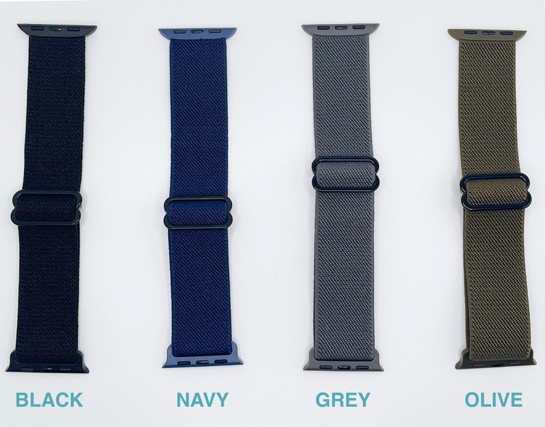 May include: Four Apple Watch bands in black, navy, grey, and olive green. The bands are made of a stretchy, woven material and have a black metal clasp.