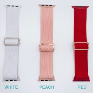 May include: Three Apple Watch bands in white, peach, and red. Each band has a rose gold buckle.