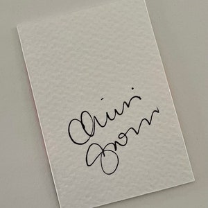May include: A white card with black cursive writing that says "Love from" on it.