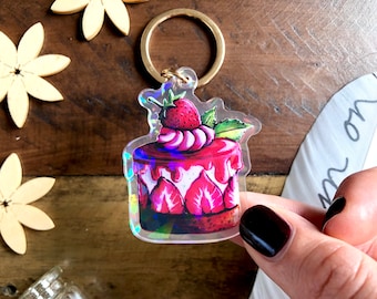 Glittering strawberry cake keychain made of acrylic glass with golden key ring as a sweet accessory or as a gift for cake fans