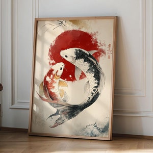 May include: A framed print depicting two koi fish swimming in a circle around a red sun. The fish are black and white with red accents. The background is a light beige with a watercolour effect.