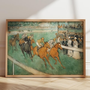May include: A framed vintage print depicts a horse race with jockeys in colorful attire. The artwork features horses in motion, a crowd of spectators, and a green field. The frame is made of light-colored wood.