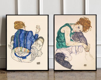 May include: Two framed art prints of Egon Schiele's drawings of seated women. The woman on the left is wearing a blue and white striped shirt and a white skirt. The woman on the right is wearing a green tank top and a black skirt.