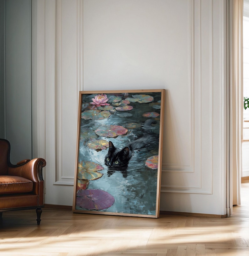 May include: A framed art print depicts a black cat swimming in a pond filled with lily pads and a pink water lily. The artwork has a vintage aesthetic, with a wooden frame and a serene, painterly style.
