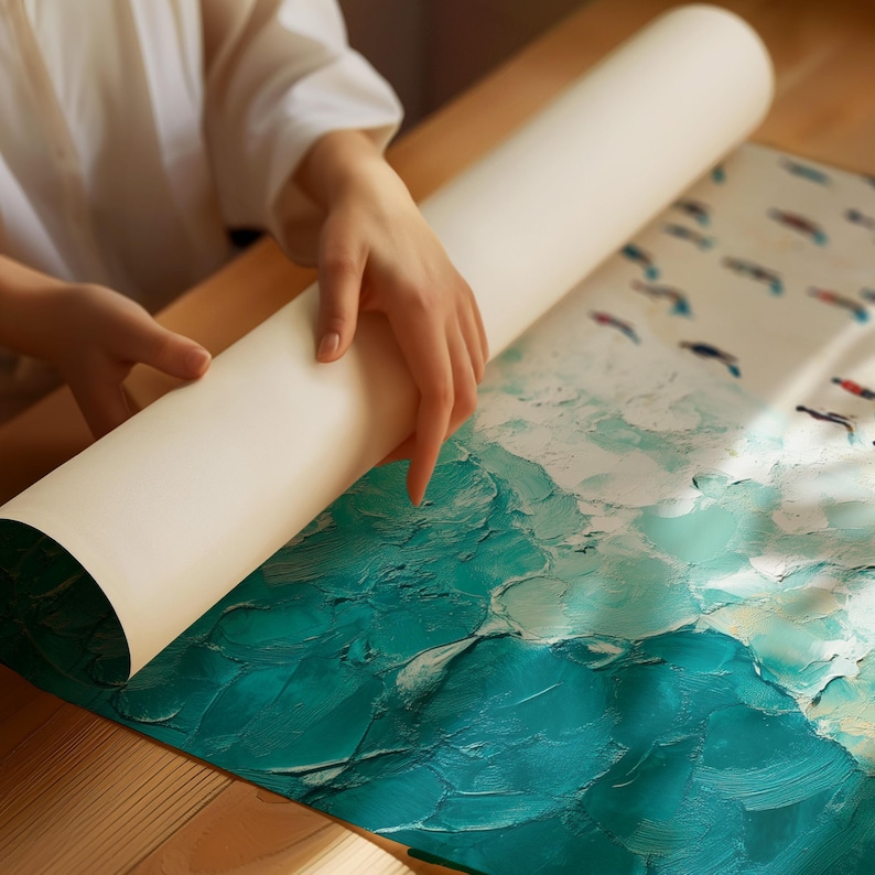 May include: A person unrolling a large canvas print of a teal and white abstract painting with a textured brushstroke effect. The painting depicts a seascape with white birds flying over the water.