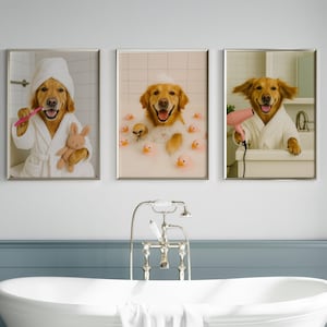 May include: Set of three framed prints featuring Golden Retrievers in a bathroom setting. One dog brushes its teeth, another bathes with rubber ducks, and the third dries its fur with a hairdryer. Each dog wears a white robe.