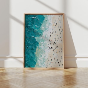 May include: A framed painting depicting a beach scene with turquoise water and white sand. The painting shows a large group of people on the beach, viewed from above.