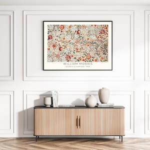 May include: A framed print of a vintage floral pattern with a white background and red, blue, green, and yellow flowers. The print has the text "WILLIAM MORRIS - MORRIS & COMPANY, 1866 -" at the bottom.
