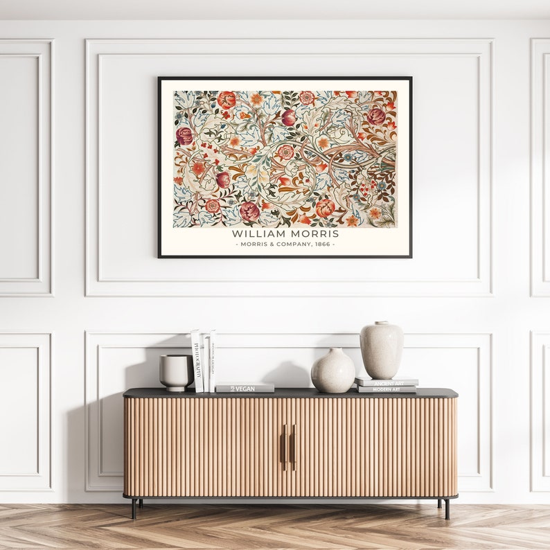 May include: A framed print of a vintage floral pattern with a white background and red, blue, green, and yellow flowers. The print has the text "WILLIAM MORRIS - MORRIS & COMPANY, 1866 -" at the bottom.