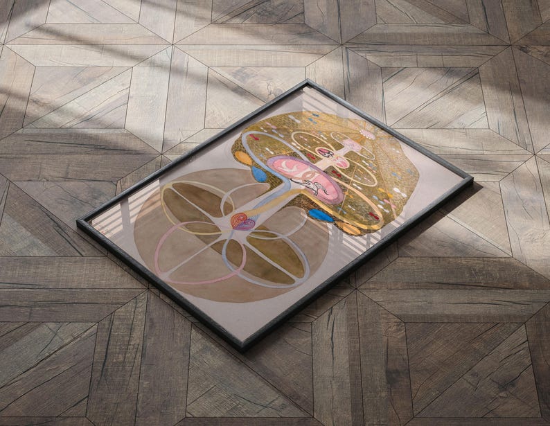 May include: A framed illustration of a tree with a complex, circular design. The tree is depicted in shades of brown, yellow, and pink, with blue and red accents. The background is a light brown wood grain.