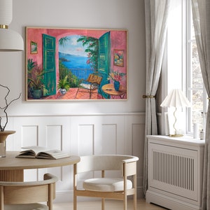 May include: A painting of a balcony overlooking a blue ocean with green trees and a pink wall. The balcony has a chair and a table with a vase of flowers.