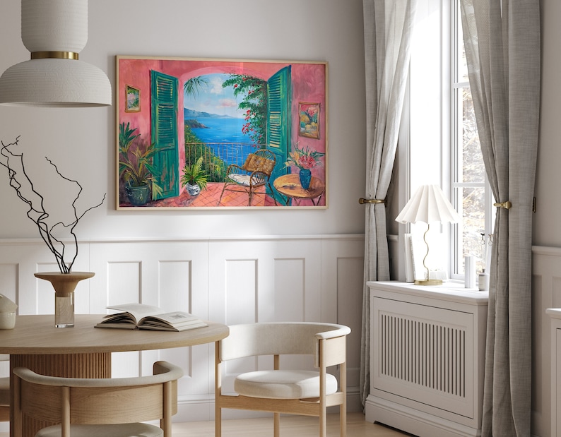 May include: A painting of a balcony overlooking a blue ocean with green trees and a pink wall. The balcony has a chair and a table with a vase of flowers.