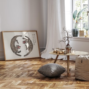 May include: A framed print of two black and white tigers in a circle, with the Chinese characters "身入虎穴, 心存正氣" written in black on a white background.